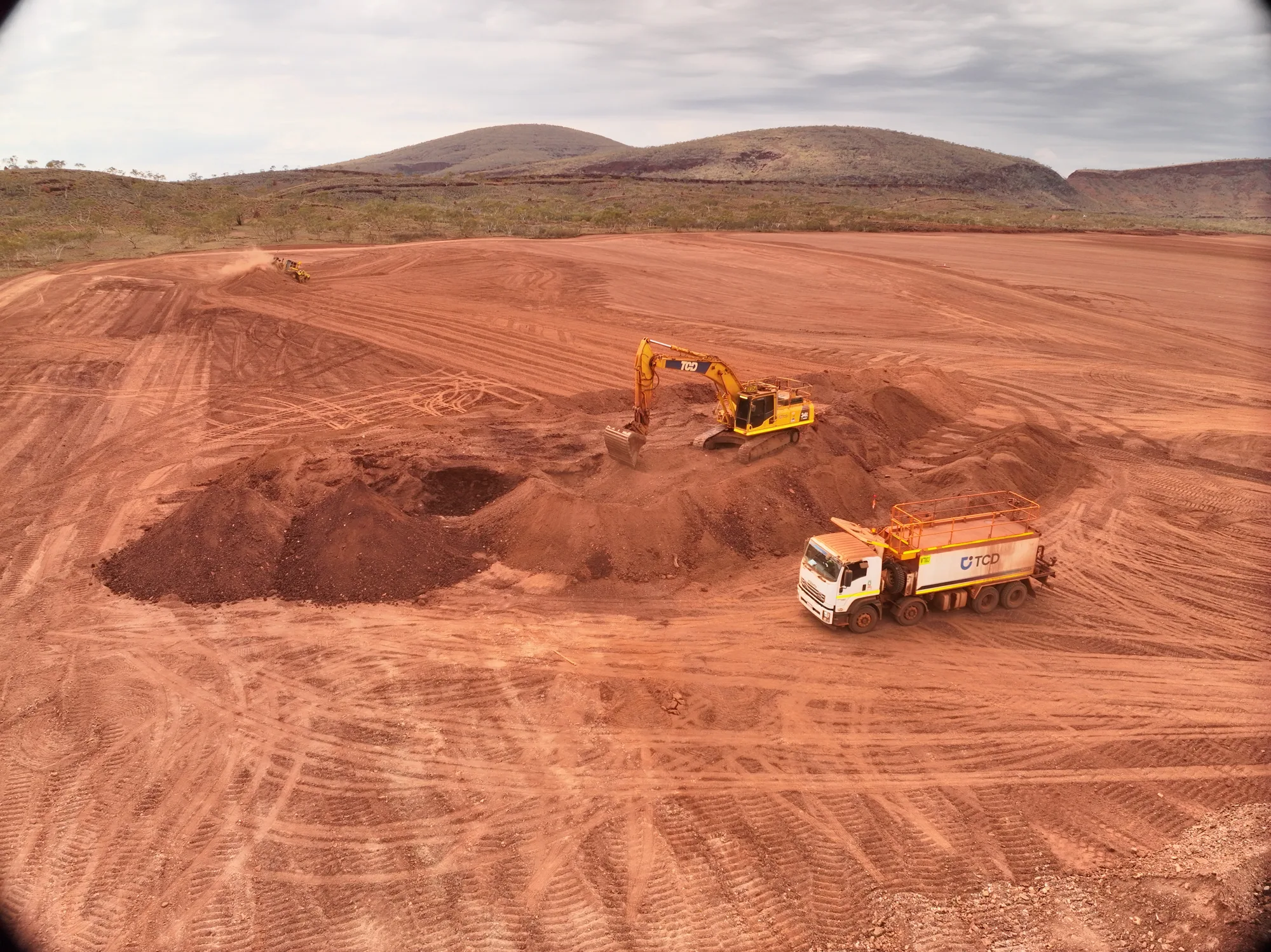 TCD excavator and water cart on bulk earthworks at the Solomon Airport Solar Hub in the Pilbara