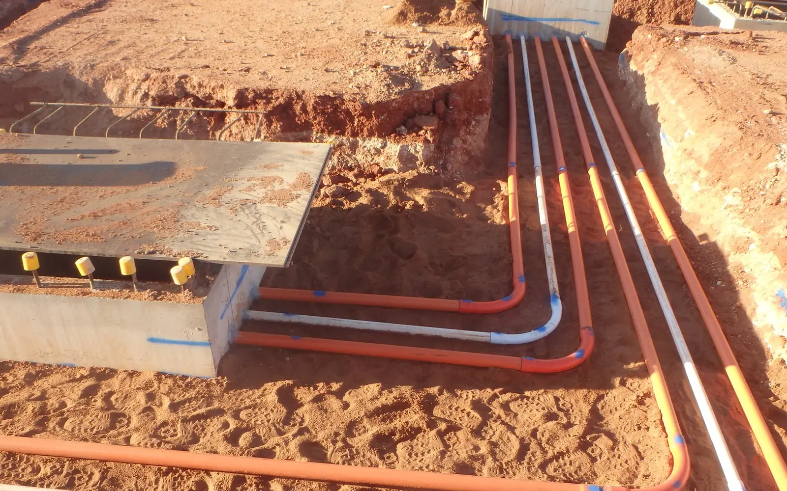 Electrical conduits laid in trenches at a Fortescue battery energy storage site in the Pilbara