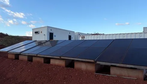 Rooftop solar panels across a row of TCD buildings