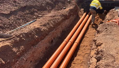 Conduits laid in a trench for ROM services at McPhee Creek
