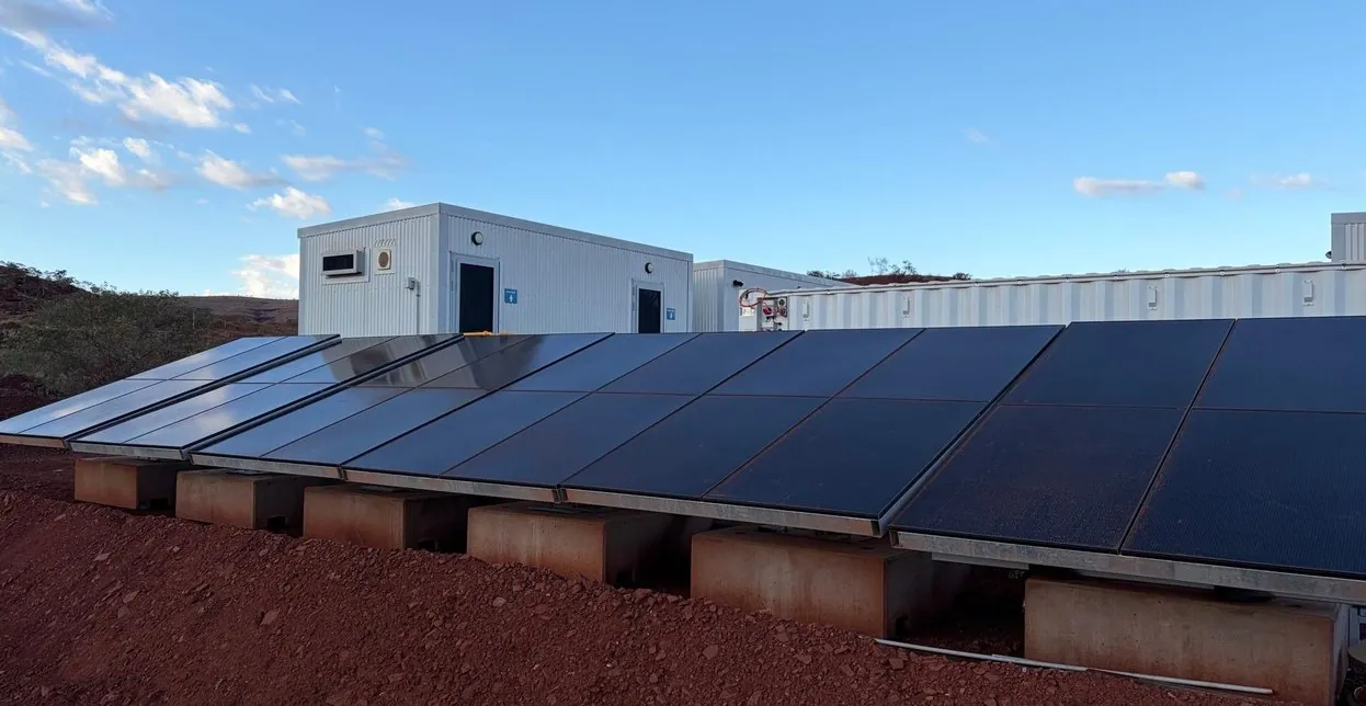 Rooftop solar across a row of TCD buildings under a clear sky